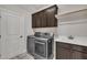 Functional laundry room with modern washer, dryer, sink, and storage cabinets at 3108 Lawson Walk Way, Rolesville, NC 27571