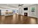 Open concept living area featuring a fireplace, hardwood floors and a kitchen with counter seating at 3108 Lawson Walk Way, Rolesville, NC 27571