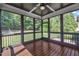 Relaxing screened porch with wooded views, ceiling fan and stained wood flooring at 3108 Lawson Walk Way, Rolesville, NC 27571