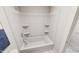 Clean bathroom with a white bathtub and shower with built-in shelving at 323 Beacon Dr, Pittsboro, NC 27312
