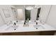 Bathroom featuring double sinks with modern faucets and a glass-enclosed shower at 323 Beacon Dr, Pittsboro, NC 27312