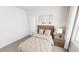 Cozy bedroom with neutral tones, a comfortable bed, and a window for natural light at 323 Beacon Dr, Pittsboro, NC 27312