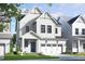 Charming two-story white home with black window trim, garage, and landscaped front yard at 323 Beacon Dr, Pittsboro, NC 27312