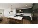 Modern kitchen featuring green cabinets, white countertops, and wooden island with seating at 323 Beacon Dr, Pittsboro, NC 27312