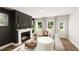 Cozy living room showcasing a fireplace, large windows, and comfortable seating at 323 Beacon Dr, Pittsboro, NC 27312