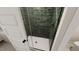 Modern shower with glass door and dark green tiled walls at 323 Beacon Dr, Pittsboro, NC 27312