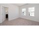 Bedroom featuring neutral carpet, white walls, and an ensuite bathroom behind a white door at 335 Beacon Dr, Pittsboro, NC 27312