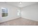 Bright bedroom with neutral carpet, white walls, and natural light from two windows at 335 Beacon Dr, Pittsboro, NC 27312