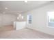 Loft area featuring light neutral carpet, bright windows, and great natural light at 335 Beacon Dr, Pittsboro, NC 27312