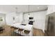 Bright kitchen with an island, sleek countertops, modern appliances and wood flooring at 335 Beacon Dr, Pittsboro, NC 27312