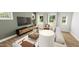 Comfortable living room featuring hardwood floors, bright windows, and stylish decor at 335 Beacon Dr, Pittsboro, NC 27312