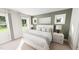 Inviting main bedroom with three bright windows, neutral color palette, and stylish decor at 335 Beacon Dr, Pittsboro, NC 27312