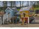 Community playground with colorful playhouses and interactive features for children at 335 Beacon Dr, Pittsboro, NC 27312
