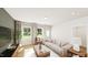 Bright living room features hardwood floors, large windows with natural light and neutral decor at 338 Beacon Dr, Pittsboro, NC 27312