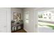 Bright foyer with a console table, stylish decor, and a view to the front yard through the glass-paneled front door at 339 Beacon Dr, Pittsboro, NC 27312