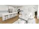 Open-concept kitchen and dining area featuring a large island, stainless steel appliances, and an elegant dining set at 339 Beacon Dr, Pittsboro, NC 27312