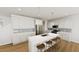 Modern kitchen boasts white cabinetry, stainless steel appliances, a large center island with seating, and stylish pendant lighting at 339 Beacon Dr, Pittsboro, NC 27312