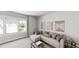 Comfortable living area with a sectional sofa, neutral decor, and large windows overlooking the backyard at 339 Beacon Dr, Pittsboro, NC 27312