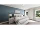 Serene main bedroom with a queen bed, soothing color palette, and natural light from two large windows at 339 Beacon Dr, Pittsboro, NC 27312