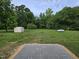 View of the backyard with storage shed and large propane tank at 3669 W Greensboro Chapel Hill Rd, Liberty, NC 27298