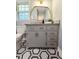 Bathroom featuring a grey vanity with gold hardware, granite countertop, and a decorative gold mirror at 3669 W Greensboro Chapel Hill Rd, Liberty, NC 27298