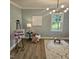Bright bedroom with stylish chandelier, hardwood floors, and view of backyard at 3669 W Greensboro Chapel Hill Rd, Liberty, NC 27298
