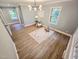 Bright bedroom featuring wood floors, modern light fixture and large windows at 3669 W Greensboro Chapel Hill Rd, Liberty, NC 27298
