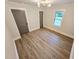 Bright bedroom with hardwood floors, white trim, and gray doors at 3669 W Greensboro Chapel Hill Rd, Liberty, NC 27298