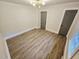 Bedroom featuring new hardwood floors and a modern lighting fixture at 3669 W Greensboro Chapel Hill Rd, Liberty, NC 27298