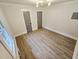 This bedroom features new floors, fresh paint, modern lighting, and two closets for ample storage at 3669 W Greensboro Chapel Hill Rd, Liberty, NC 27298