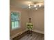Bright bedroom with a modern light fixture and large window offering a view of the landscaped exterior at 3669 W Greensboro Chapel Hill Rd, Liberty, NC 27298