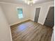 Bright bedroom with hardwood floors, white trim, and modern light fixture at 3669 W Greensboro Chapel Hill Rd, Liberty, NC 27298