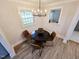 Bright dining area features new floors, a modern light fixture, and large windows at 3669 W Greensboro Chapel Hill Rd, Liberty, NC 27298