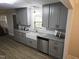 Updated kitchen features gray cabinets, granite countertops, and stainless steel dishwasher at 3669 W Greensboro Chapel Hill Rd, Liberty, NC 27298