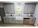 Updated kitchen features gray cabinets, granite countertops, and stainless steel dishwasher at 3669 W Greensboro Chapel Hill Rd, Liberty, NC 27298
