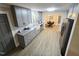 Open-concept kitchen featuring gray cabinets, granite countertops, and stainless steel appliances at 3669 W Greensboro Chapel Hill Rd, Liberty, NC 27298