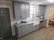 Modern kitchen with stylish grey cabinets, granite countertops, stainless steel appliances and a farmhouse sink at 3669 W Greensboro Chapel Hill Rd, Liberty, NC 27298