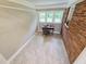 This home office features a large window, neutral paint, and a stylish accent wall at 3669 W Greensboro Chapel Hill Rd, Liberty, NC 27298