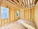 Unfinished bedroom area with wood framing, insulation, and two windows at 3824 Coach Lantern Ave, Wake Forest, NC 27587
