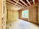 Unfinished bedroom with wood frame and window providing natural light at 3824 Coach Lantern Ave, Wake Forest, NC 27587