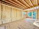 Unfinished room featuring bare wood framing, walls, and windows, offering a glimpse of the construction's adaptability at 3824 Coach Lantern Ave, Wake Forest, NC 27587