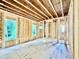 Bright interior framing displays exposed beams, studs, and window openings, highlighting the customization potential for discerning buyers at 3824 Coach Lantern Ave, Wake Forest, NC 27587
