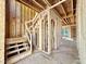 Wooden framework shows an incomplete staircase with open wall studs and natural light, presenting customization options at 3824 Coach Lantern Ave, Wake Forest, NC 27587