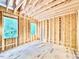 Unfinished bedroom with wood framing, exposed beams and sheeting, and an eye towards future finishes at 3828 Coach Lantern Ave, Wake Forest, NC 27587