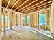 Framed living room with windows with views of the trees outside and sunlight at 3828 Coach Lantern Ave, Wake Forest, NC 27587