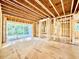 Unfinished living room with exposed beams and framing, offering a spacious open floor plan with natural light at 3828 Coach Lantern Ave, Wake Forest, NC 27587