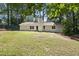 Spacious backyard with a lush green lawn and mature trees at 3916 W Allen, Raleigh, NC 27603