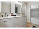 Modern bathroom featuring double vanity with black fixtures, and an adjacent water closet at 3916 W Allen, Raleigh, NC 27603