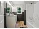 Modern bathroom with a double vanity, stylish mirrors, and a shower-tub combo at 3916 W Allen, Raleigh, NC 27603