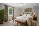 Cozy bedroom with an iron bed frame, neutral decor, and a window offering natural light at 3916 W Allen, Raleigh, NC 27603